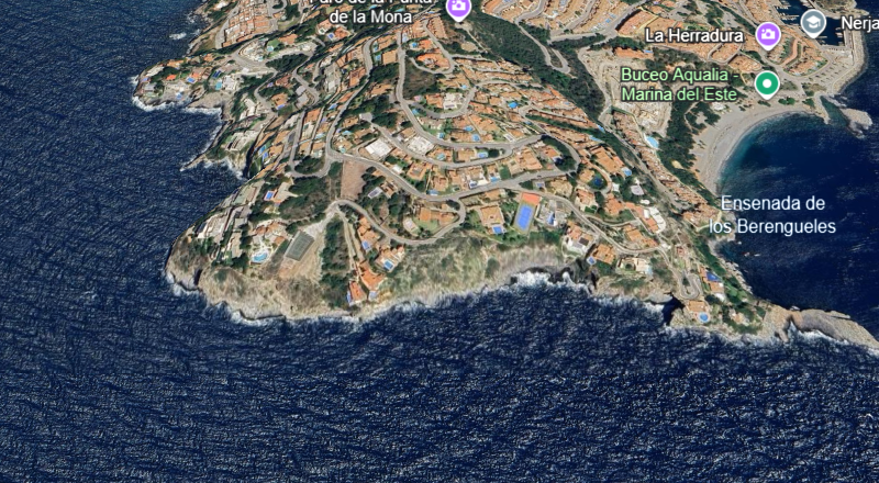 Rocky headland of Punta de la Mona with clear turquoise water and rugged cliffs near La Herradura, a popular dive site for Wahoo Divers Malaga.