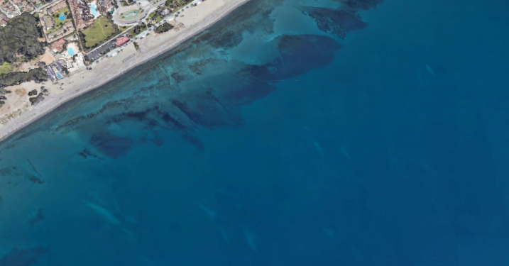 San Pedro coastline near Marbella with sandy beach, calm Mediterranean water, and distant mountains, a scenic coastal area visited by Wahoo Divers Malaga.